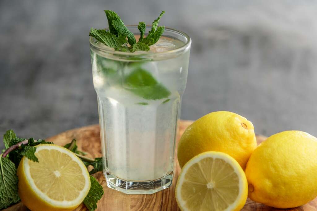 A glass of lemonade on a sunny table, symbolizing everyday recovery in real life through small, nourishing choices.