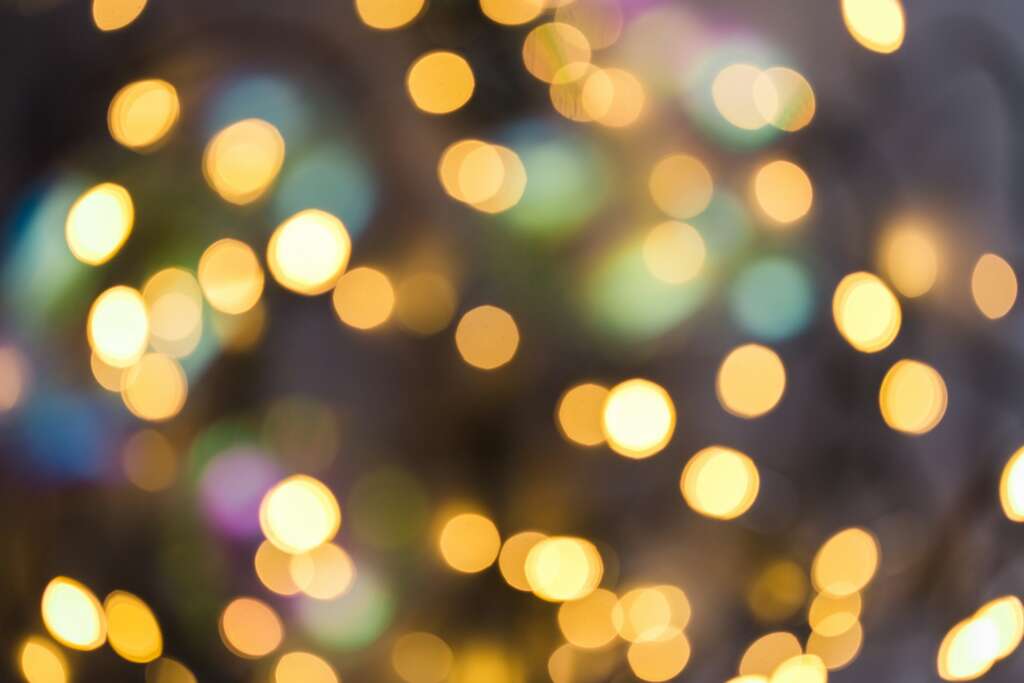 Soft, out-of-focus holiday lights creating a warm, calm atmosphere of peace and simplicity.